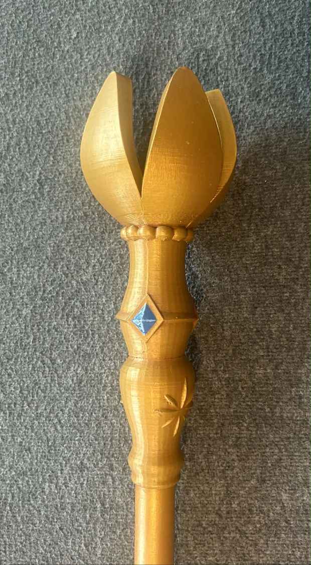 Close-up of handmade gold scepter prop top with blue gem detail